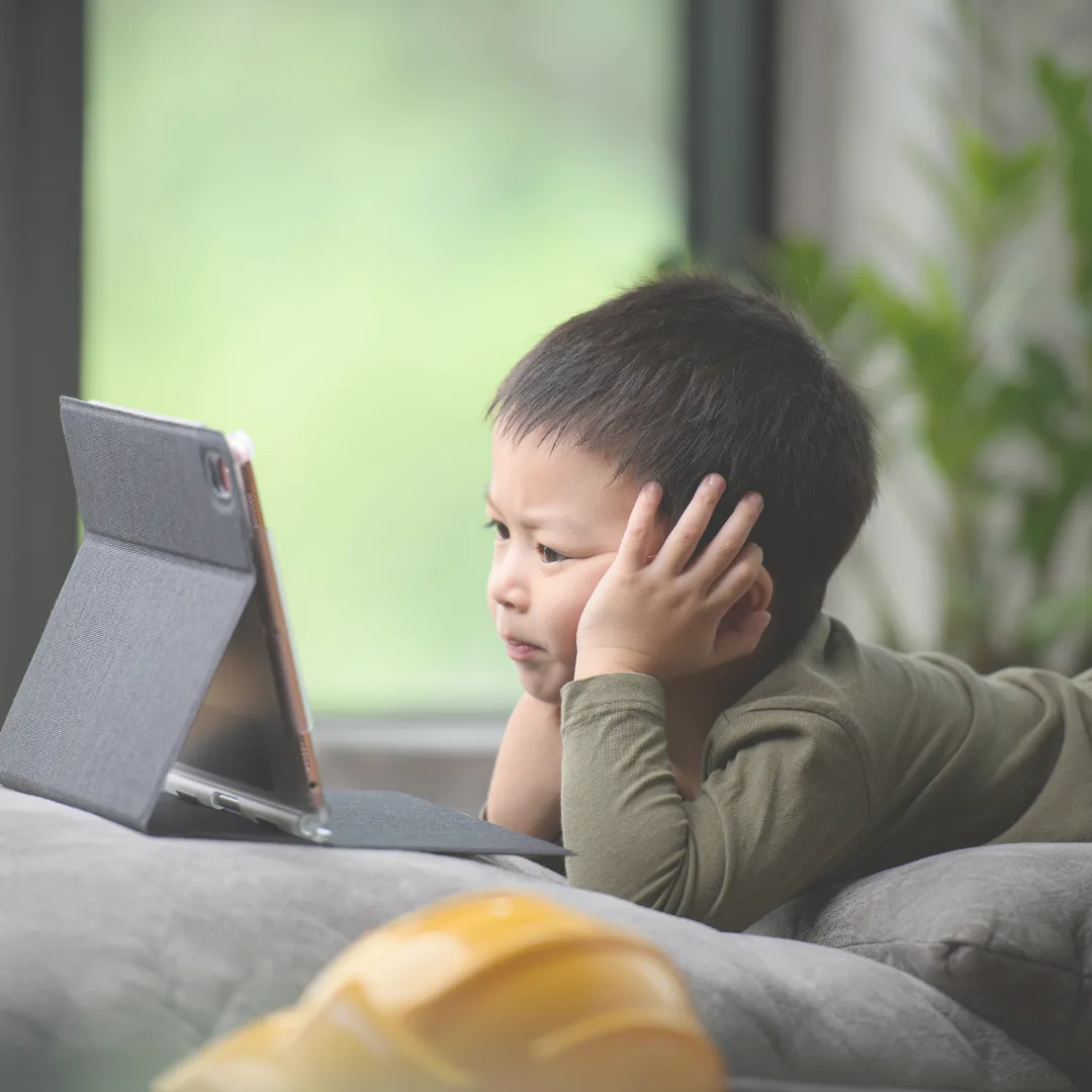 Young child staring at a tablet, representing early-stage exposure to screen addiction psychology.