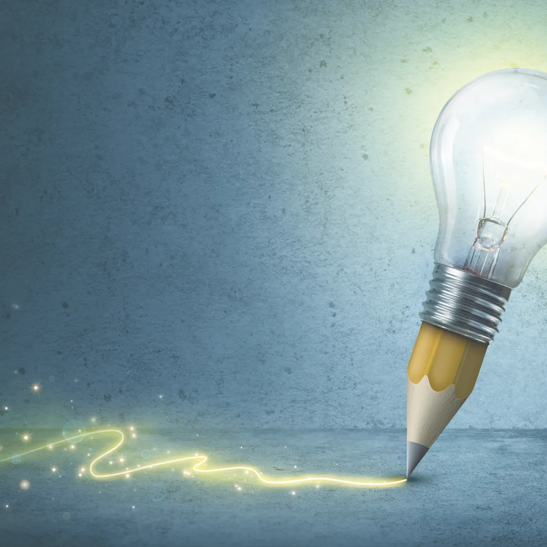 A pencil with a glowing lightbulb for its body draws a sparkling line, symbolizing the moment of creative inspiration.