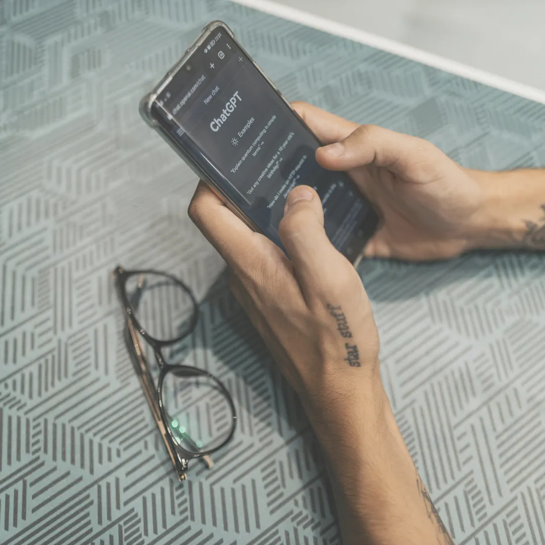 A person's hands holding a smartphone and interacting with an AI chatbot, representing the current state of today's AI mental health tools.