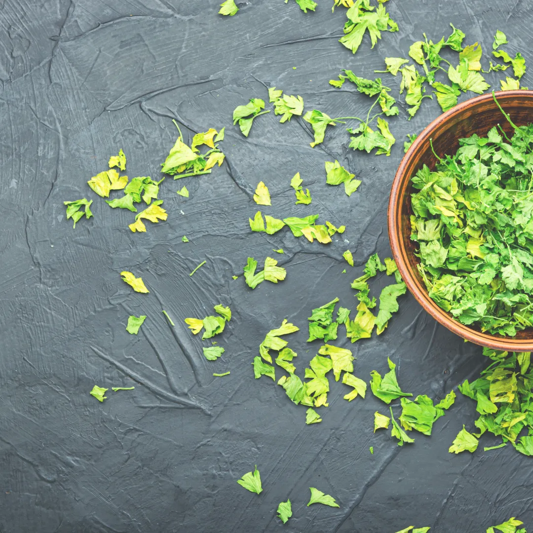 Fresh chopped parsley in a wooden bowl, a powerful detox herb for cleansing the body naturally.