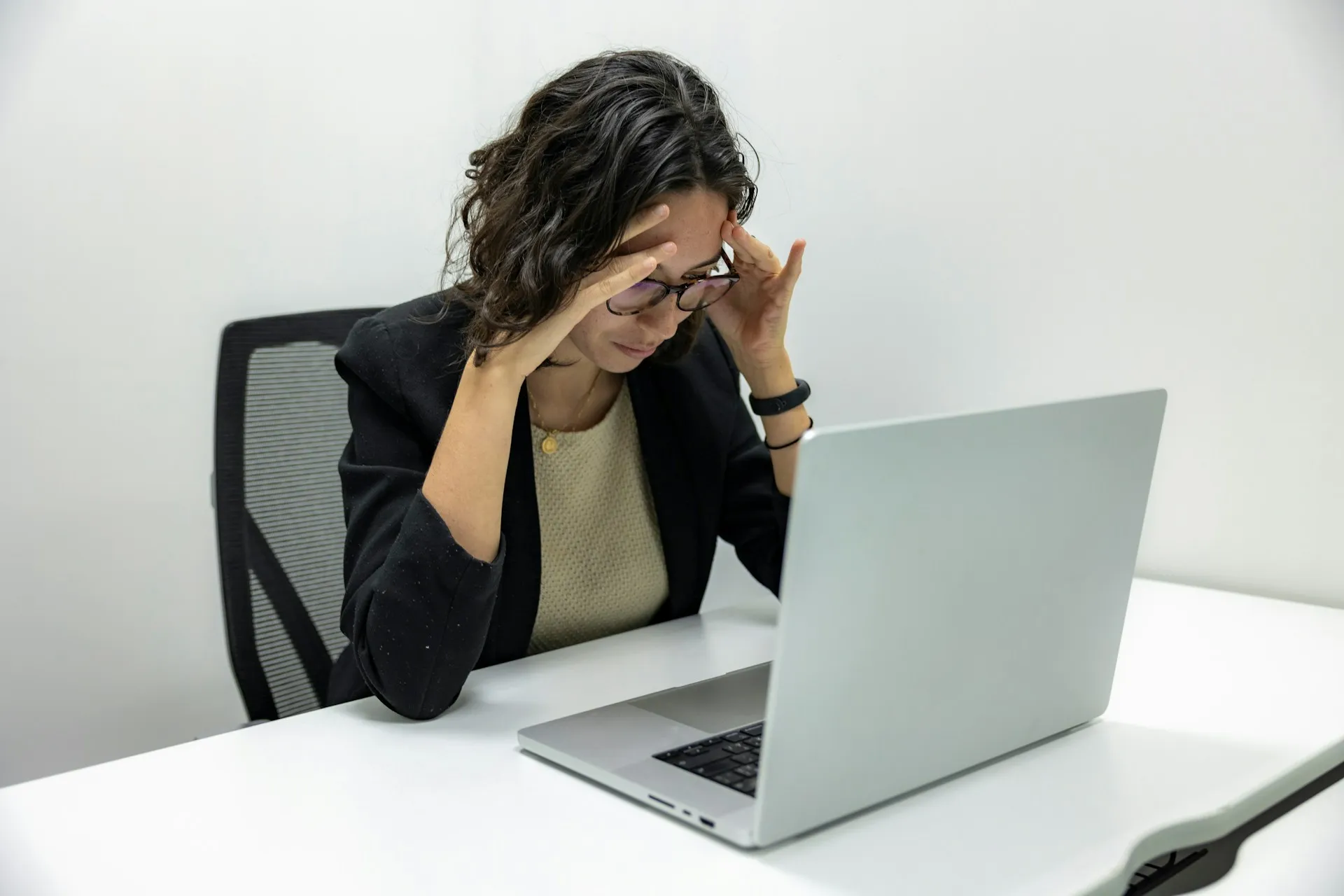 Person sitting cross-legged holding a bowl of quinoa, broccoli, tomatoes, and mozzarella