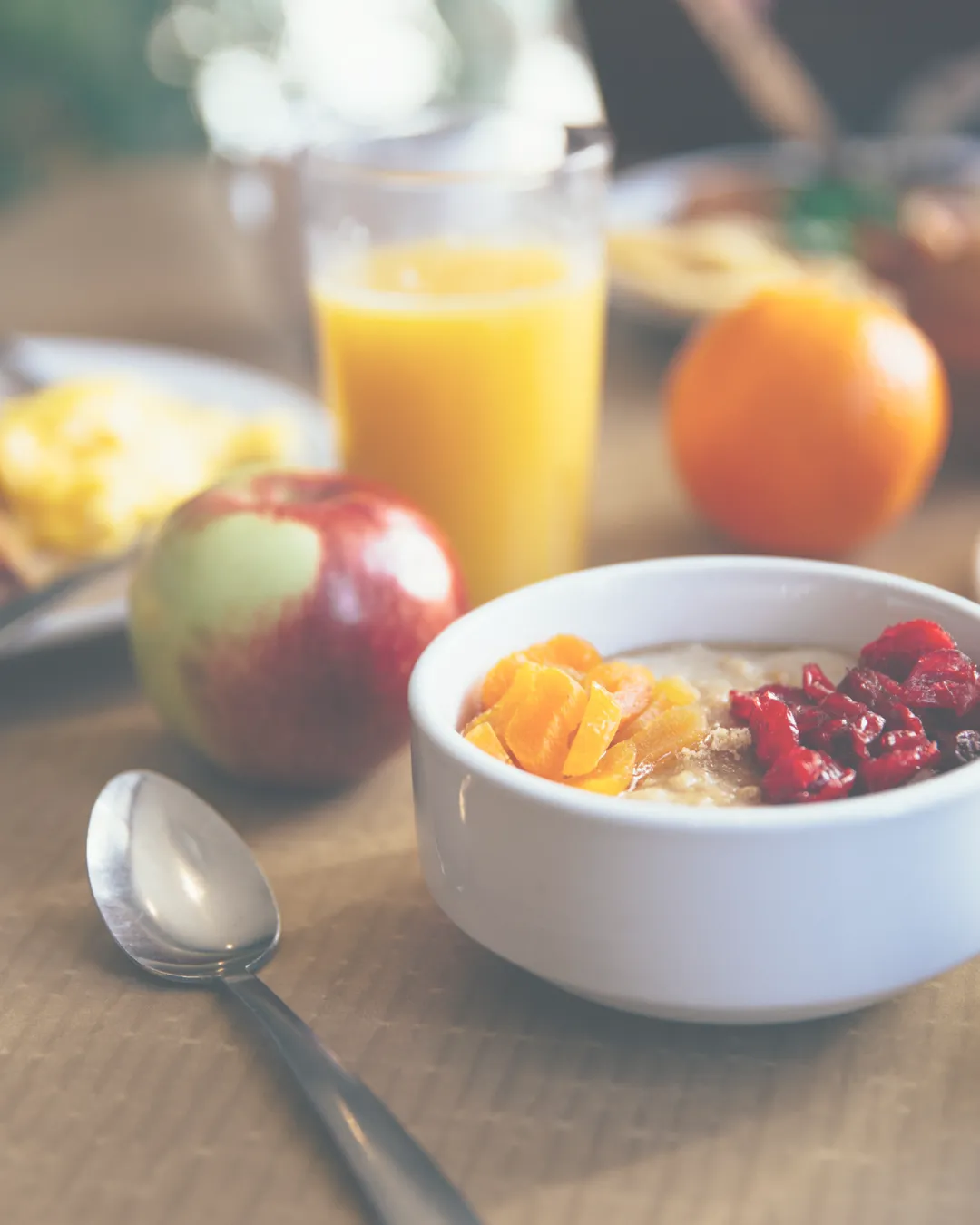 Nutritious breakfast with fruits, oats, and juice, supporting longevity-focused wellness.