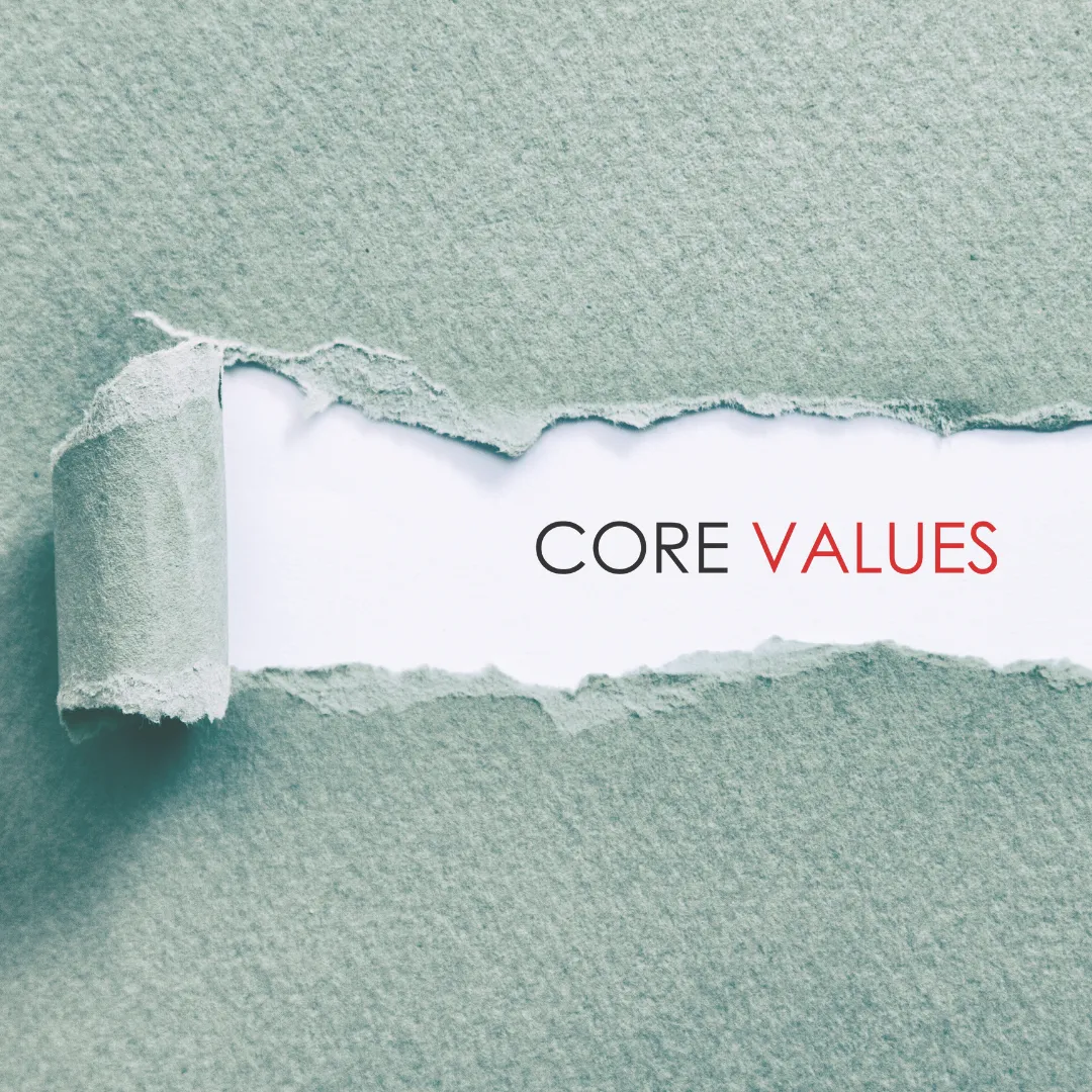 Torn paper revealing the words 'Core Values,' illustrating the concept of aligning your work with personal principles for occupational wellness.