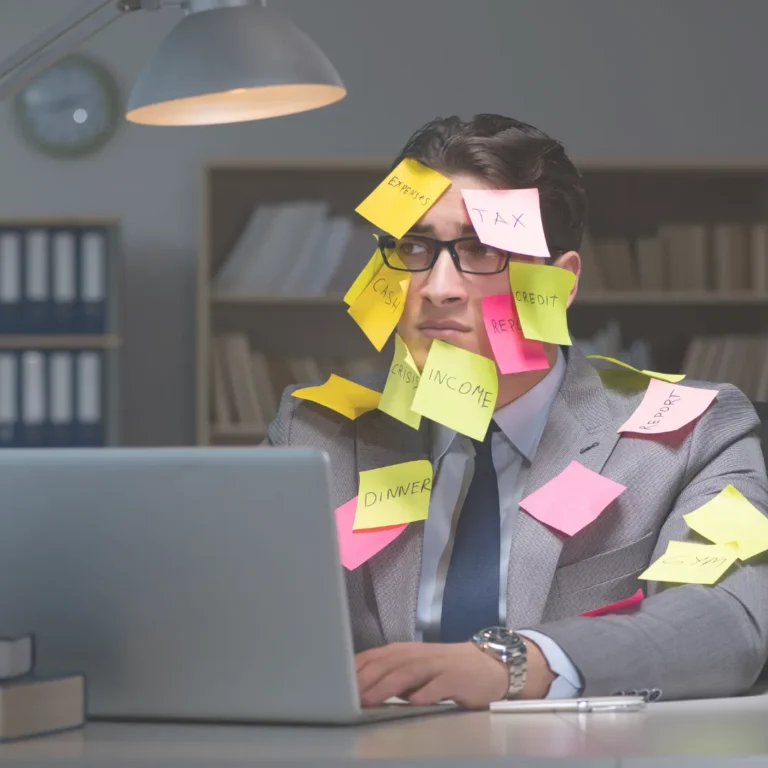 Businessman overwhelmed by tasks, covered in reminder notes