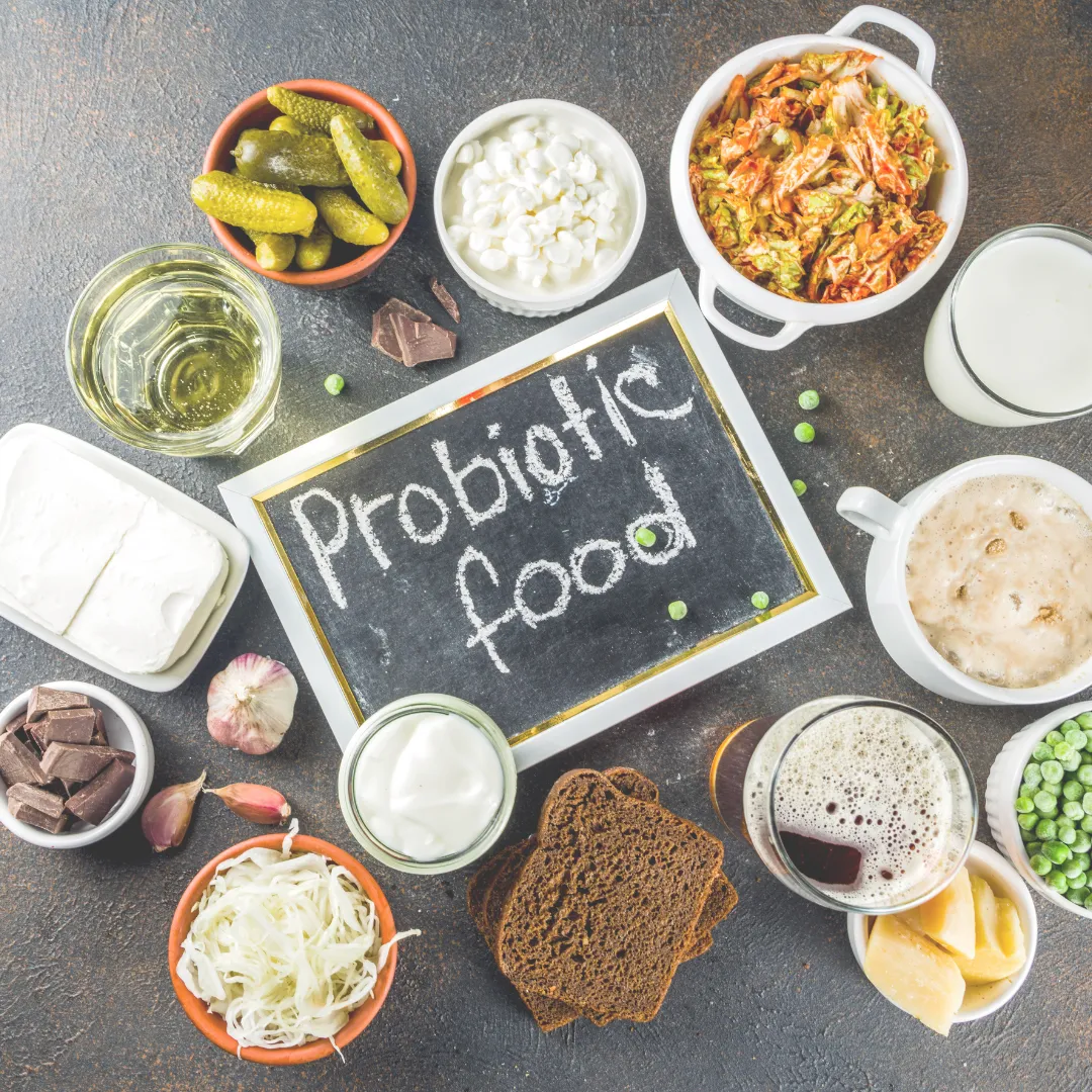 An assortment of probiotic foods including kimchi, kefir, pickles, and sauerkraut, all essential for improving gut microbiome diversity and supporting mood via the gut-brain connection.